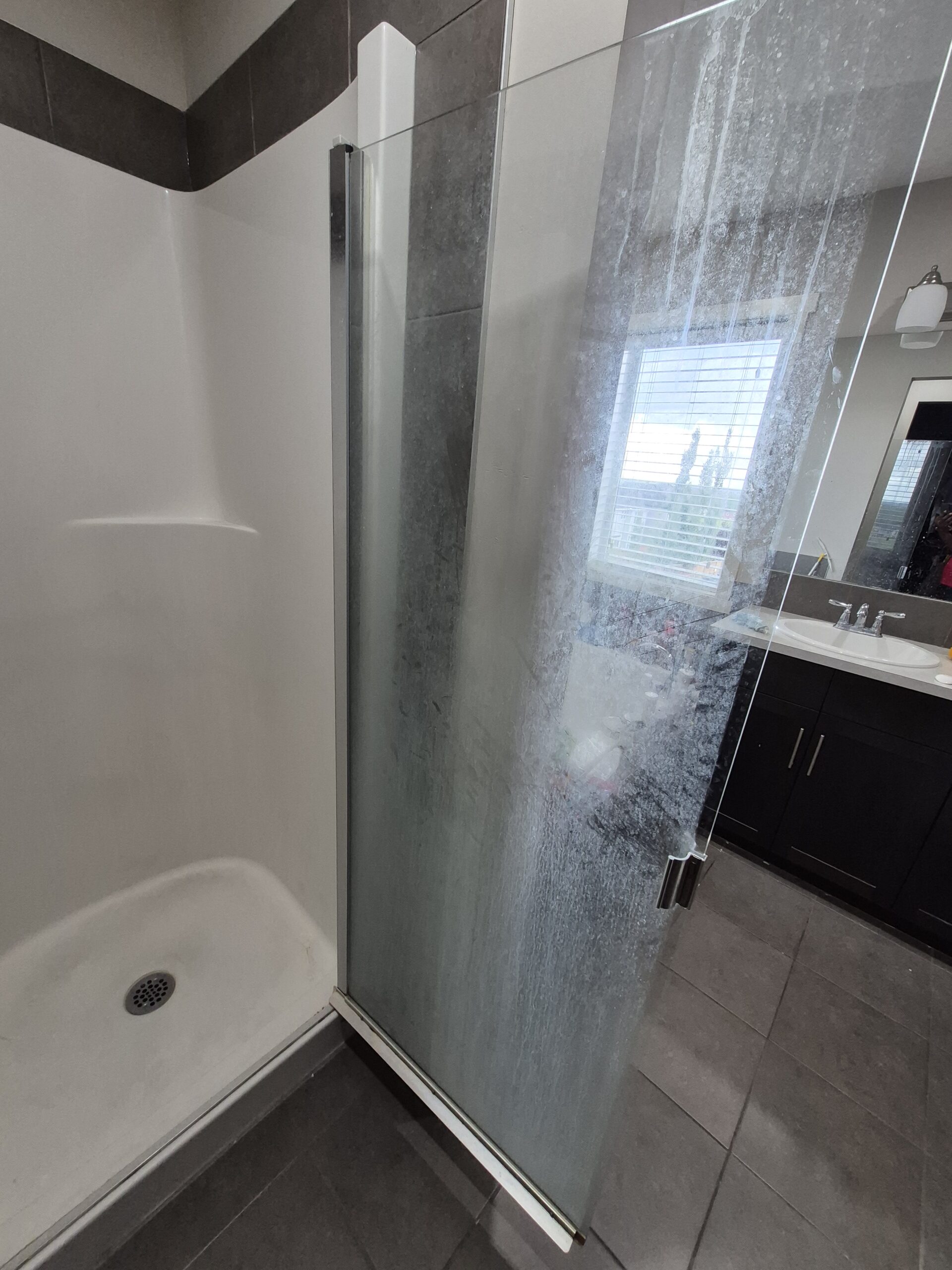 Before: limescale on shower door